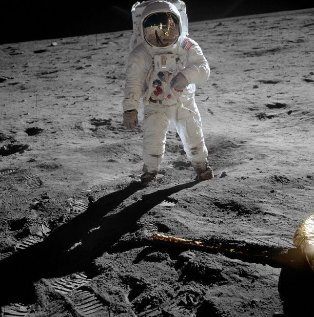 Buzz Aldrin, with Armstrong and the LM's shadow reflected in his helmet visor
